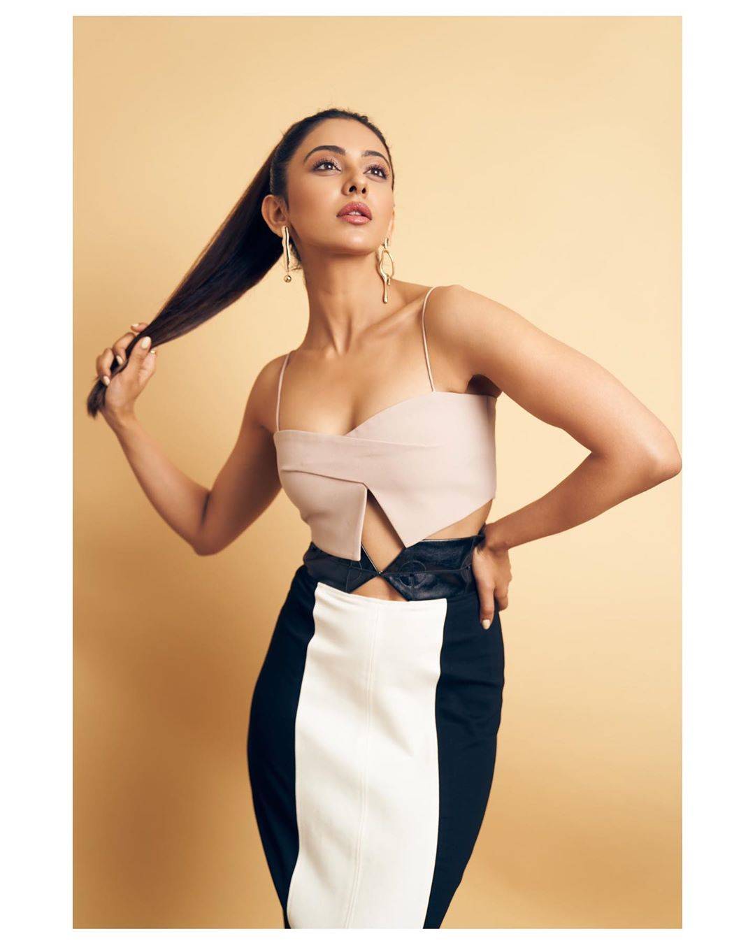 The statement-making look was polished off with a pair of interesting earrings from Goss Babe; and Hairstylist Tina Mukharjee shows good taste with a long pony. - Fashion Models