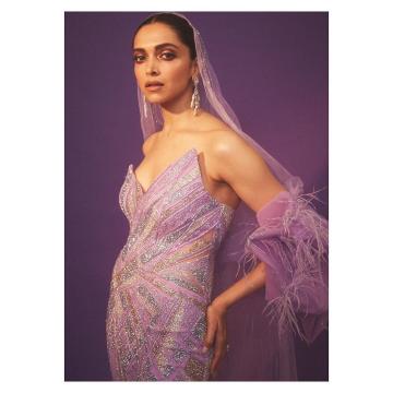 The sharply cut off-shoulder gown from Gaurav Gupta has gold and silver shimmer and the veil has an extravagant train, complete with faux feathers  - Fashion Models