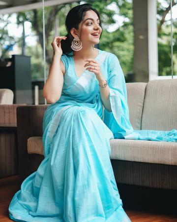 The bright sky blue cotton saree has a simple silver border and a sleeveless blouse - Fashion Models