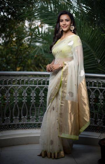 The white saree has gold zari, which is repeated in its green blouse along with floral designs - Fashion Models