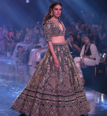 The lehenga from label Kalki has elbow-length sleeves and a pleated umbrella cut skirt - Fashion Models