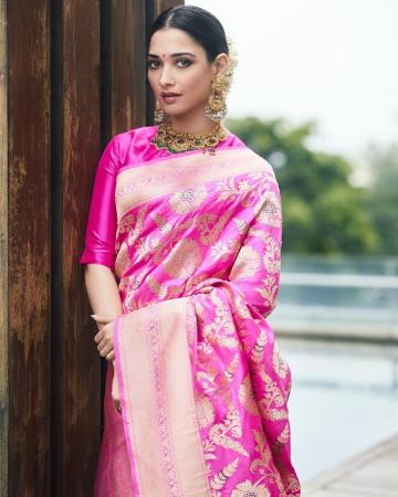 The vivid pink saree has abundant gold floral patterns and goes well with the closed neck blouse which has conservatively stylish elbow-length sleeves - Fashion Models