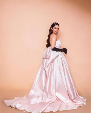 The pale satin off-shoulder gown has a voluminous skirt that blows out into an extended train with a huge bow in the back - Fashion Models