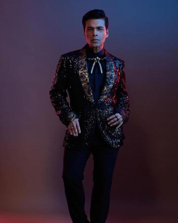 The shirt underneath and the trousers are both black and draws attention to the gold speckle-and-doodle design of the coat - Fashion Models