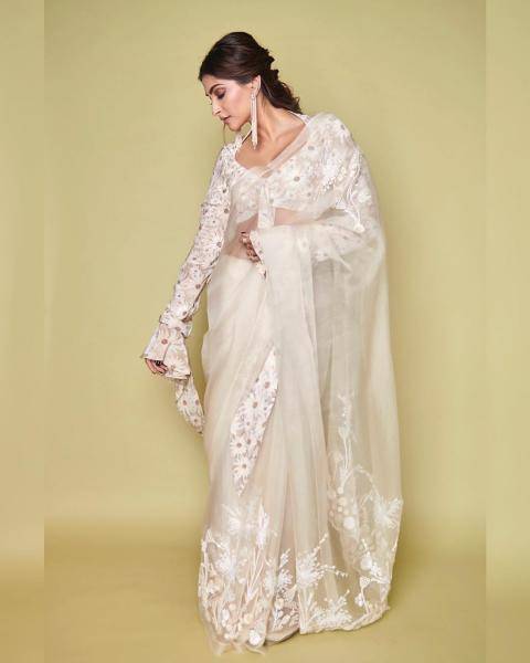 The ivory organza embroidered saree finds its character in the huge daisies on the blouse - Fashion Models